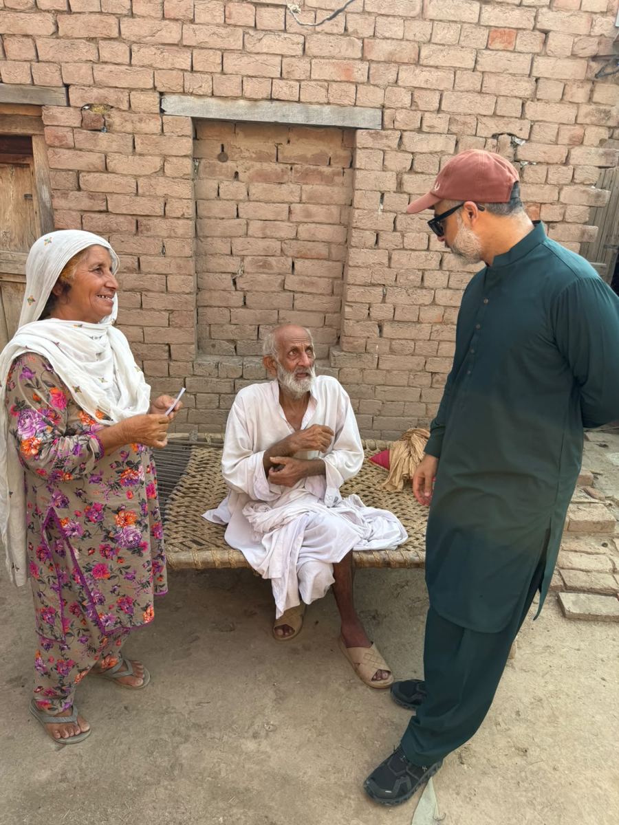 Monthly stipend being handed to an adopted family